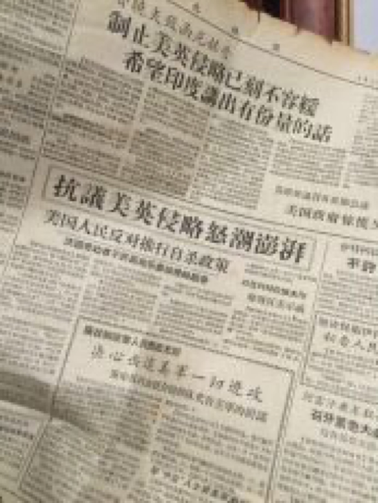一份发黄的旧报纸，竖排大字标题写着制止美英侵略、抗议美英侵略